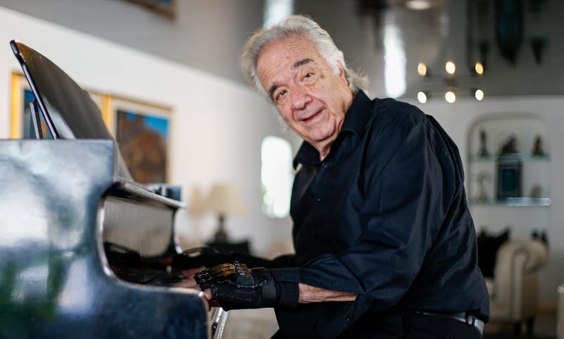 Brazilian pianist Joao Carlos Martins, 79, plays the piano wearing mechanic gloves during a interview with AFP, at his home in Sao Paulo, Brazil, on January 29, 2020.