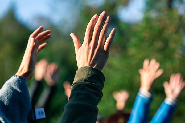 Group of people putting their hands in the air