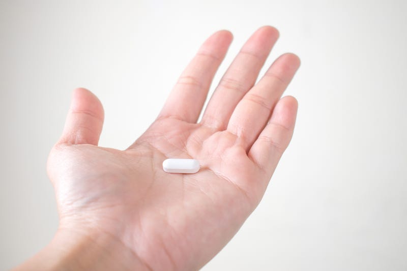 Man holding pill stock photo.
