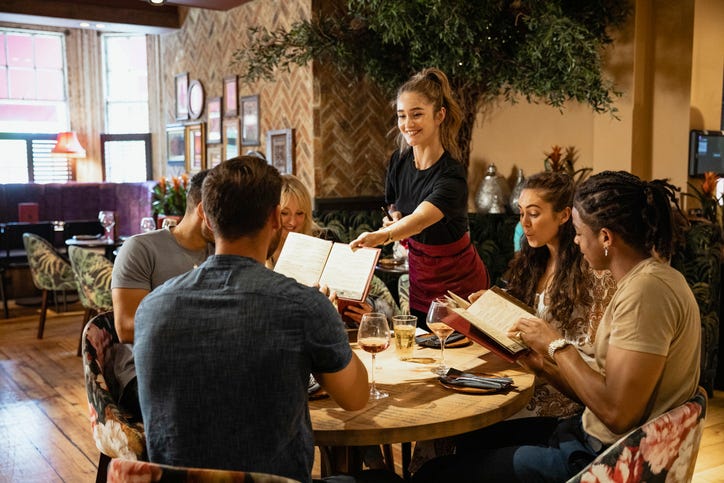 server at a restaurant in a stock image