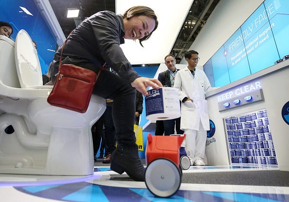 RollBot delivering a toilet paper roll 