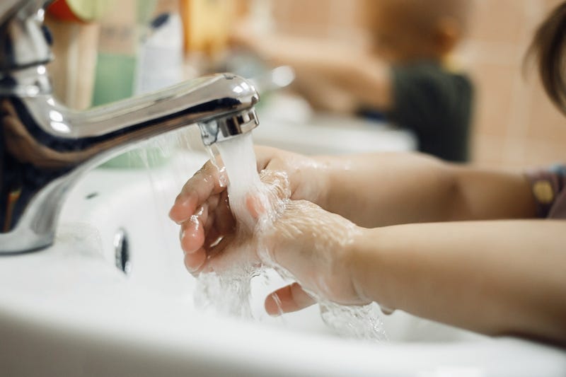 FILE: Schoolchild washing hands.