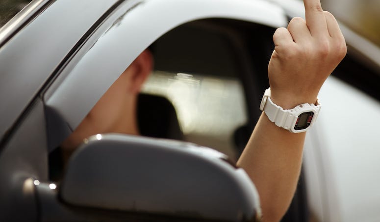 Man flipping the bird, driving, middle finger