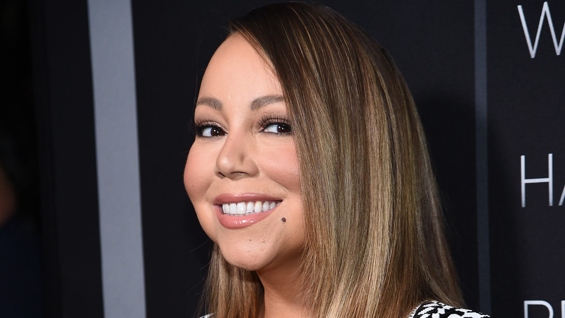 Mariah Carey rocks black gown in a hot tub to celebrate another week at number 1