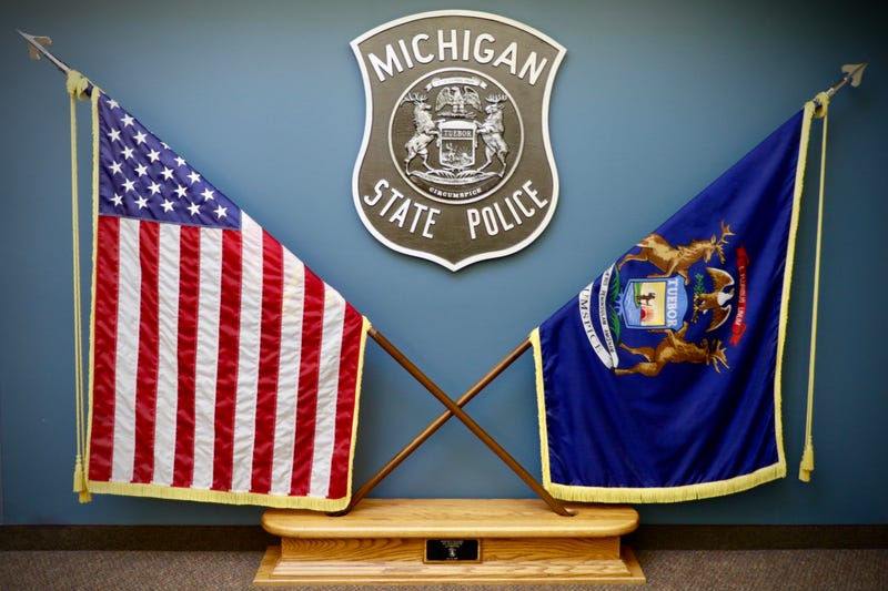 United States flag and Michigan State flag on display at the Michigan State Police Headquarters