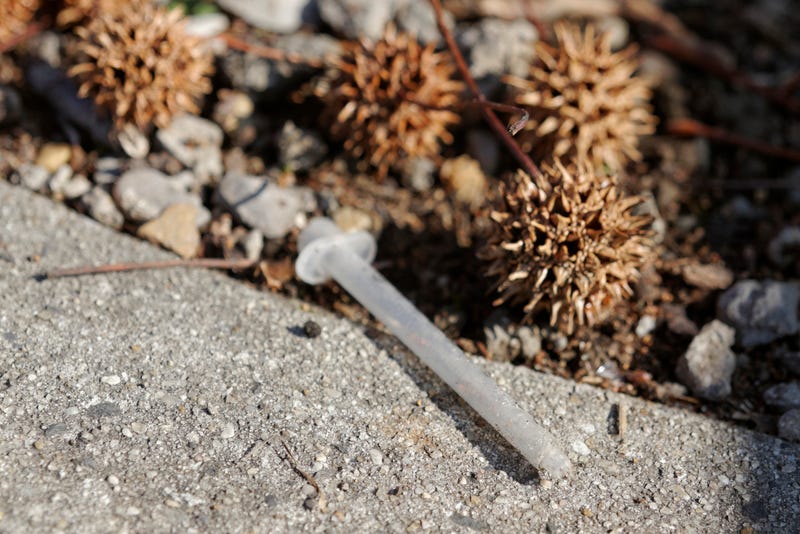 FILE: A used syringe lays discarded.
