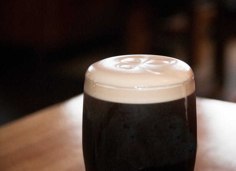 dark beer with shamrock in foam