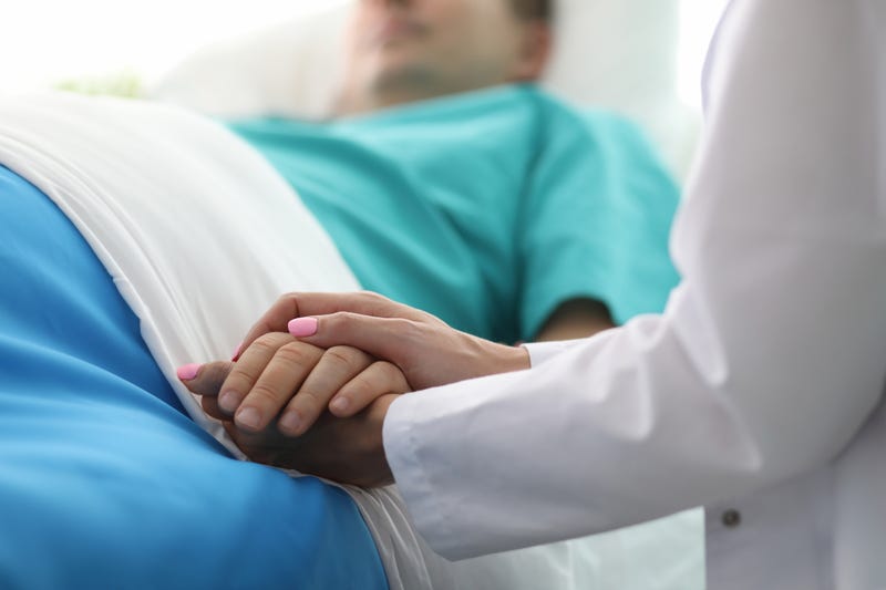 Man in hospital bed stock image