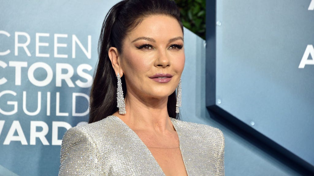 Catherine Zeta-Jones, 52, flaunts toned abs dancing in crop top and leggings