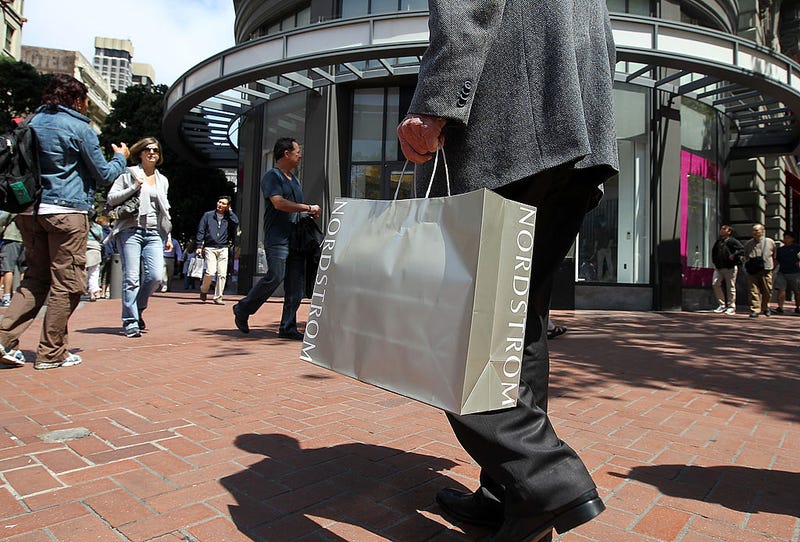 A shopper carries a Nordstrom bag as he walks along Market Street July 29, 2011 in San Francisco, California.