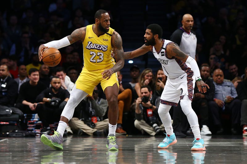 LeBron James #23 of the Los Angeles Lakers posts up against Kyrie Irving #11 of the Brooklyn Nets at Barclays Center on January 23, 2020 in New York City.