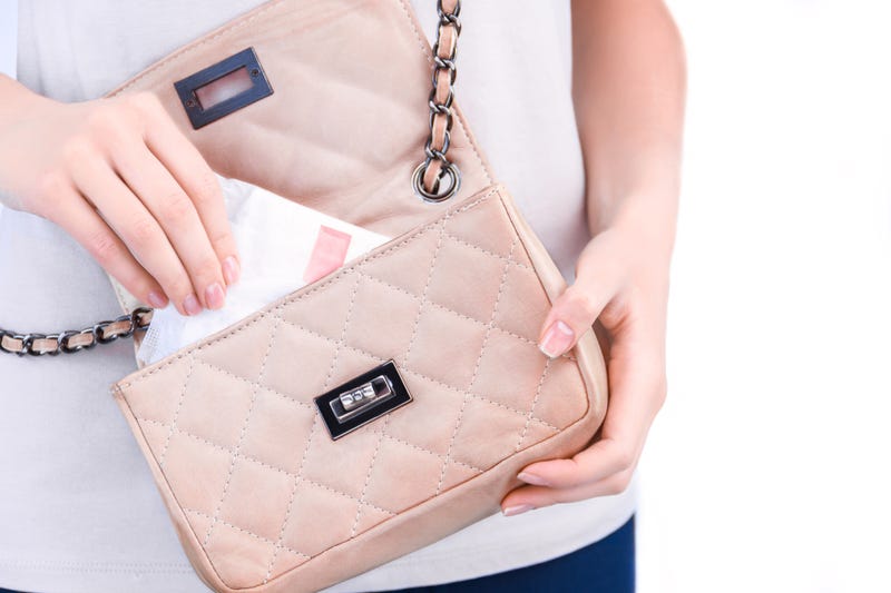 female hand is taking out of bag sanitary pad