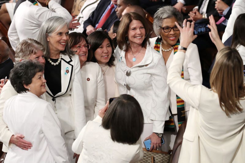 Female members of Congress dressed in white