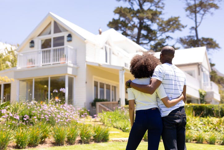Happy Couple Outside Of Their House