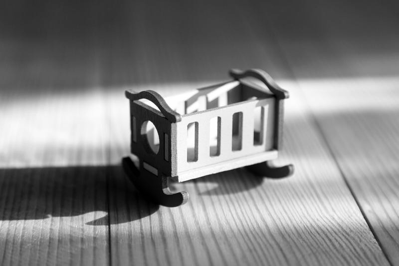 empty crib toy. Black and white.