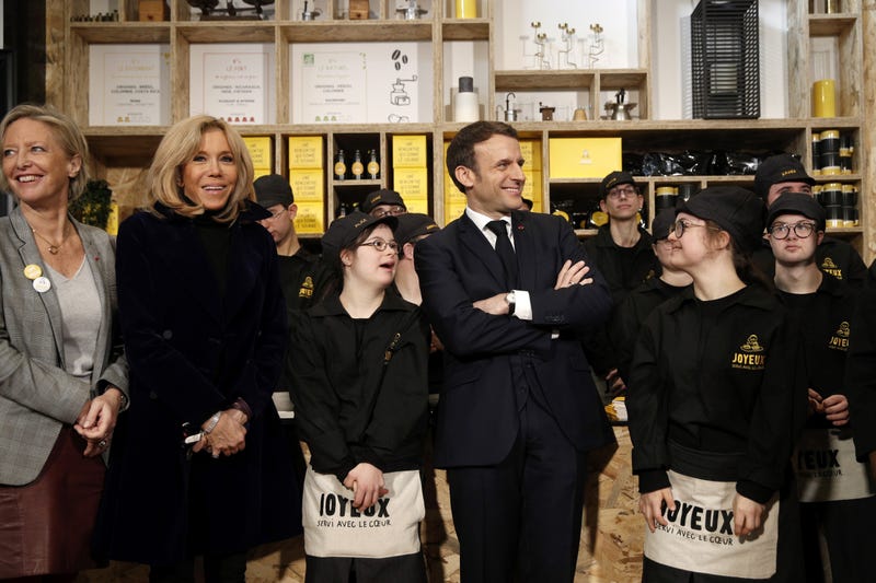 Secretary of State in charge of People with Disabilities Sophie Cluze (L), French President's wife Brigitte Macron (2nd L) and French President Emmanuel Macron (2nd R) attend the inauguration ceremony of the new Café Joyeux on the Champs Elysees in Paris on March 9, 2020.