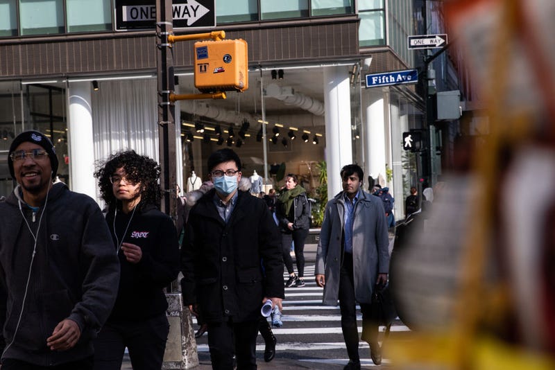 A man wearing a protective mask walks on the street on March 13, 2020 in New York City.