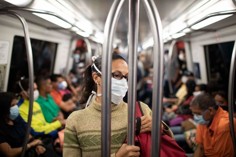 A woman wears a medical mask while traveling in the Caracas Metro on the 1st day of closure of the capital city during the Quarantine in the capital city due to the arrival of the COVID-19 virus.