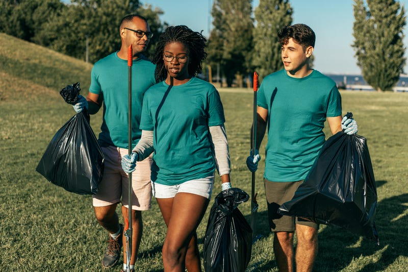 A volunteer group cleans up a park.