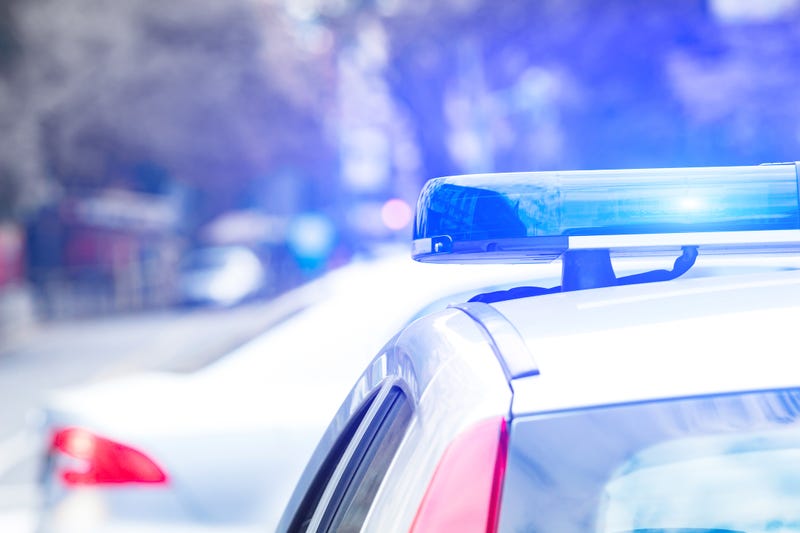 Police car with blue lights on the crime scene in traffic