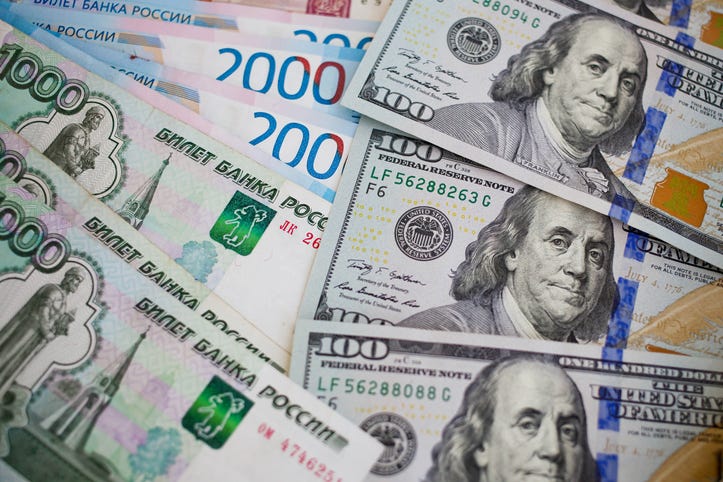 Rubles and hundred dollar bills.