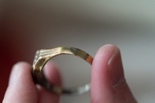 Woman holding unfinished gold ring