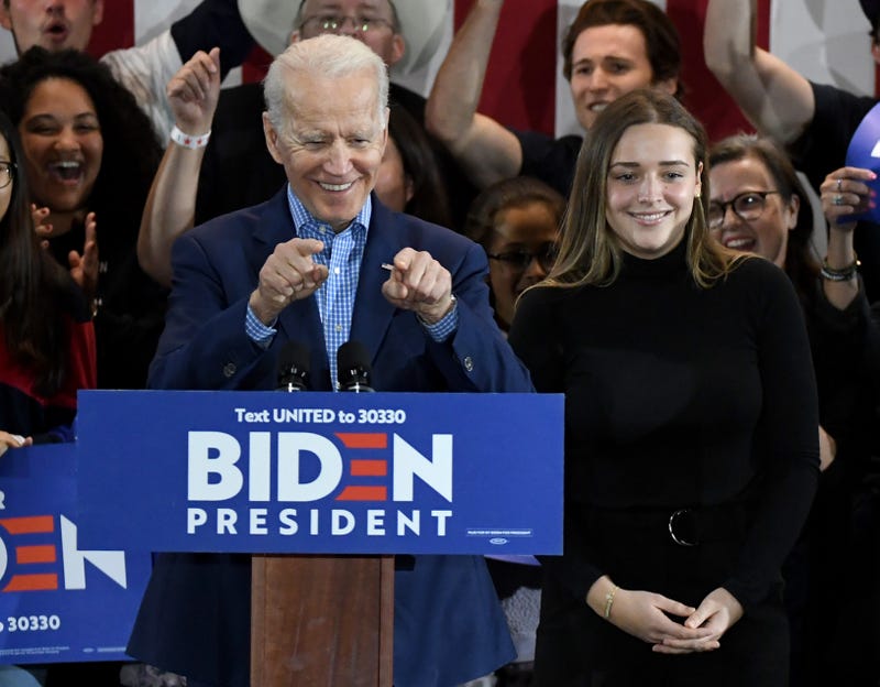 Democratic presidential candidate former Vice President Joe Biden (L) and his granddaughter Finnegan Biden are greeted as they arrive at a Nevada caucus day event at IBEW Local 357 on February 22, 2020 in Las Vegas
