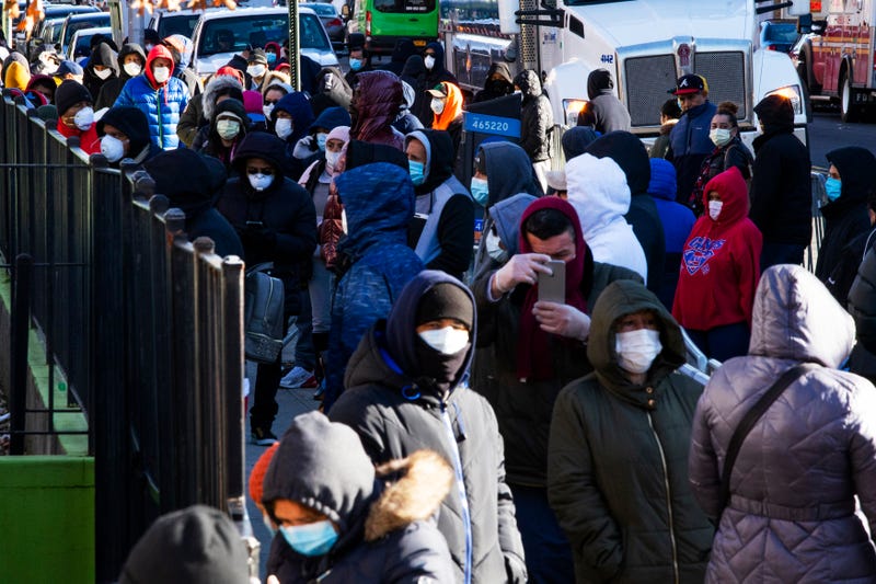 People line up outside Elmhurst Hospital to get tested for COVID-19 on March 24, 2020 in Queens