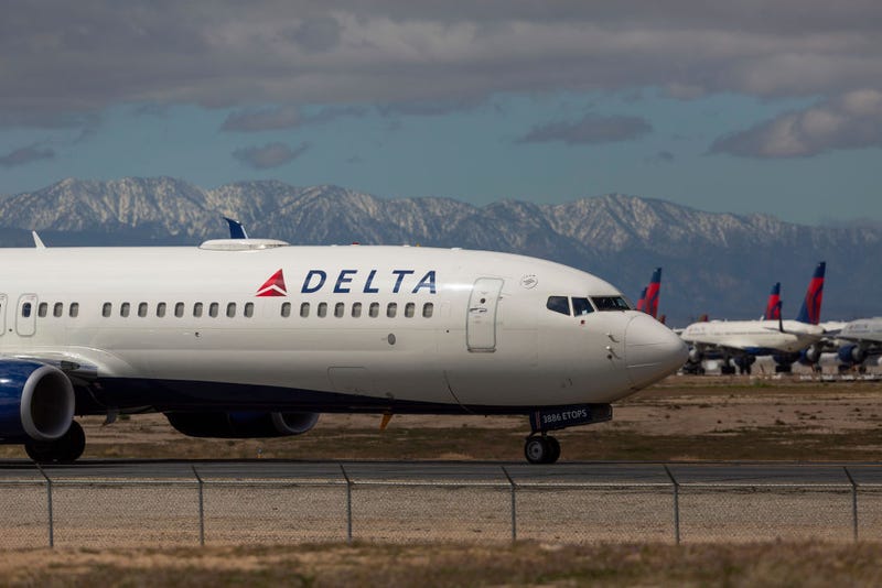 A Delta Air Lines jet taxis to be parked with a growing number of jets at Southern California Logistics Airport (SCLA) on March 24, 2020 in Victorville, California.