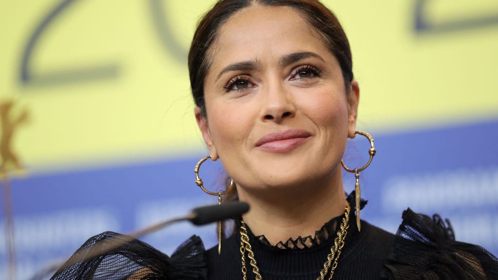 Salma Hayek, 54, soaks up the sun in a plunging swimsuit