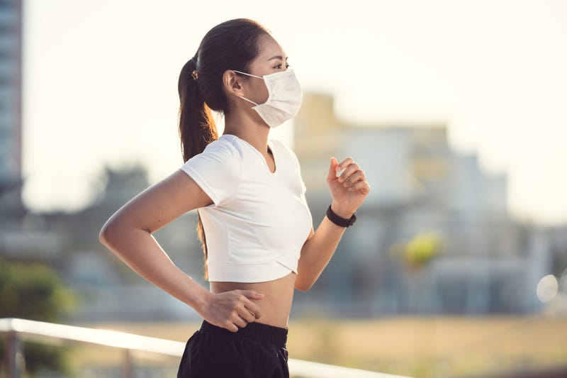 Woman runners morning exercise she wears a nose mask