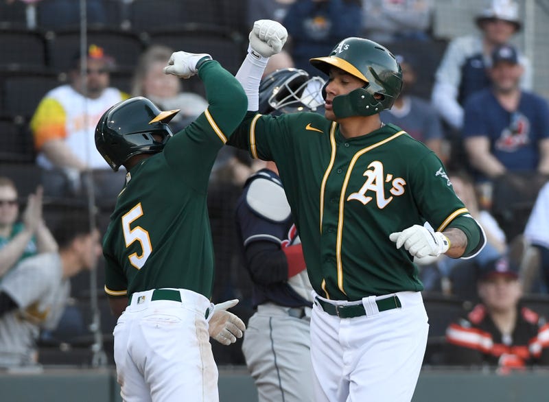ony Kemp #5 of the Oakland Athletics congratulates teammate Edwin Diaz #85 as he crosses home plate after hitting a two-run home run in the eighth inning against the Cleveland Indians during their exhibition game at Las Vegas Ballpark on February 29, 2020 in Las Vegas