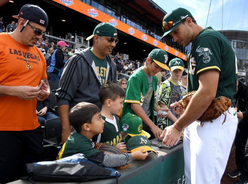 Matt Olson #28 of the Oakland Athletics signs autographs for fans before an exhibition game against the Cleveland Indians at Las Vegas Ballpark on February 29, 2020 in Las Vegas, Nevada.