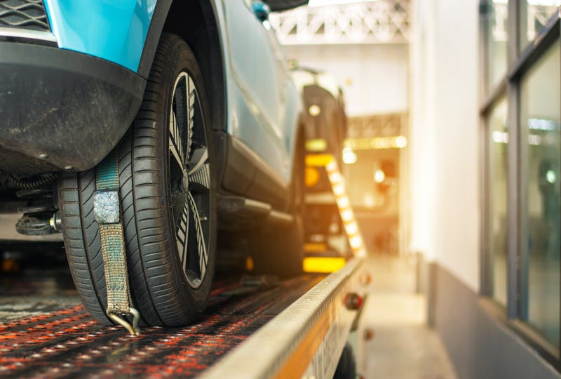 Stock image of car on tow truck bed