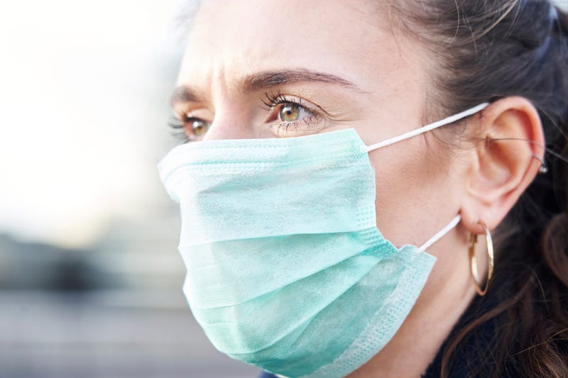 Woman wearing blue surgical mask