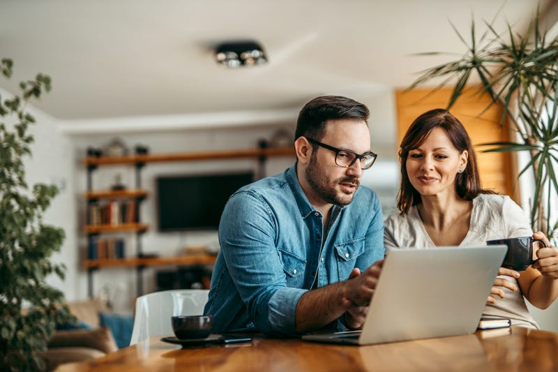 Portrait of a casual business people looking at laptop at workplace