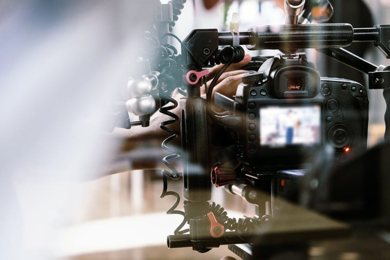 Filming with professional camera background.