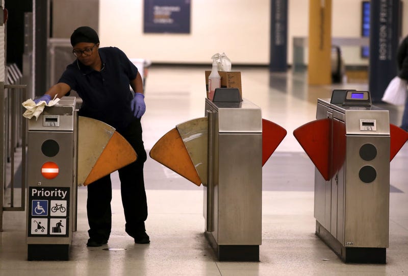 A worker wipes down fare gates at the Montgomery Street Bay Area Rapid Transit (BART) station on March 07, 2020 in San Francisco, California.