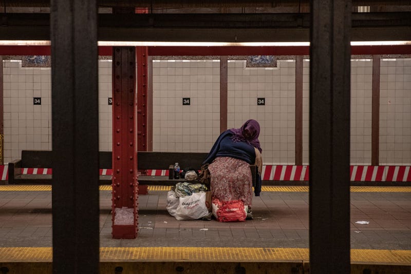 A person with bags of belongings sleeps on a 34th Street subway platform on April 28, 2020 in New York City. The station is one of eight where the "vast majority" of homeless New Yorkers seek shelter.