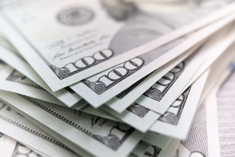 File photo showing a stack of one hundred dollar bills spread out on a taple. 