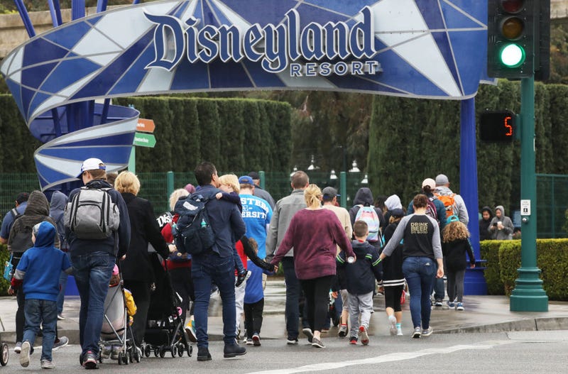 Disneyland visitors enter the famed amusement park on March 13, 2020, in Anaheim, California.