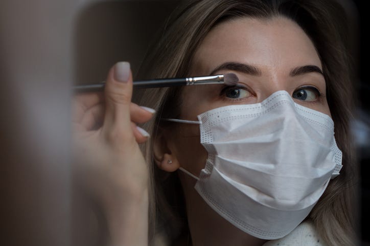 Applying Make Up In A Mask