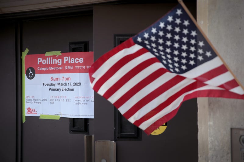 American flag waving outside of a polling location