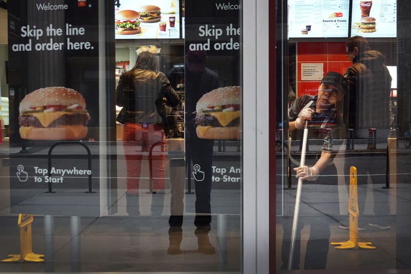 A worker cleans the floor in a McDonald's restaurant in the Chicago Loop on March 19, 2020 in Chicago, Illinois.