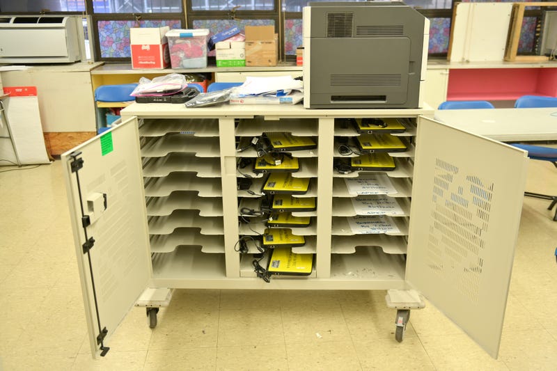 A cart is used to hold and organize school-owned laptops to be distributed to students in need for remote learning at Yung Wing School P.S. 124 in the Manhattan borough of New York City.
