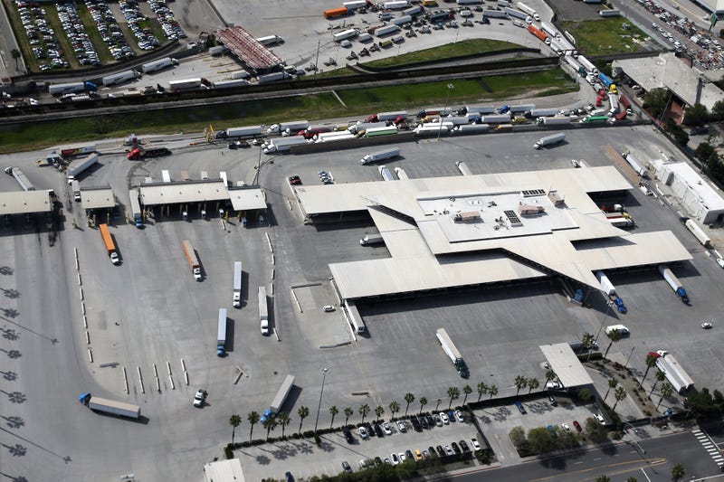 Commercial freight trucks line up to cross into the United States from Mexico through the U.S. Customs and Border Protection - Otay Mesa Port of Entry during the coronavirus (COVID-19) pandemic on March 20, 2020 in San Diego, California.