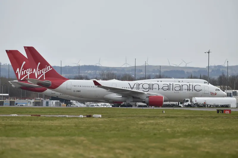 Virgin Atlantic planes sit on the runway at Glasgow Airport on March 21, 2020 in Glasgow, Scotland.