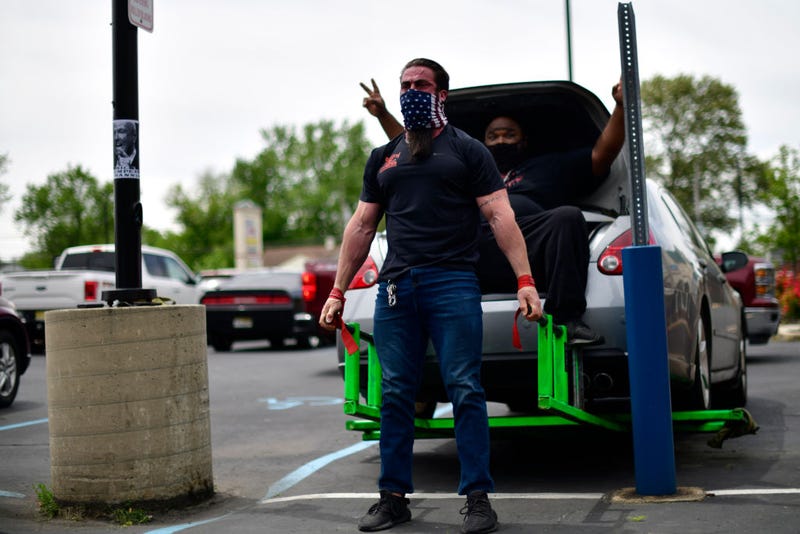 Ian Smith, co-owner of Atilis Gym lifts a car in the parking lot on May 20, 2020 in Bellmawr, New Jersey.