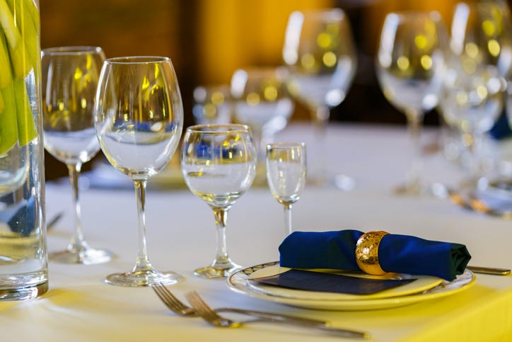 Glasses for wine and champagne on a served table at a banquet