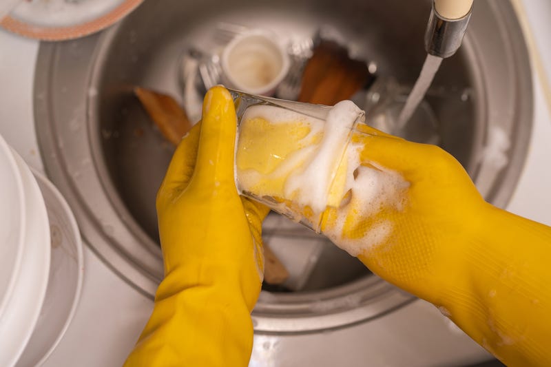 Hands cleaning a glass container